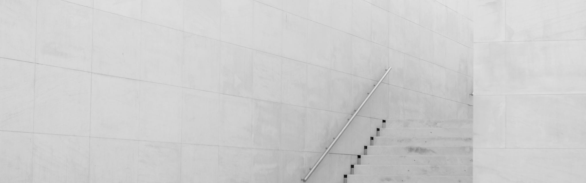 A minimalist white concrete architectural staircase