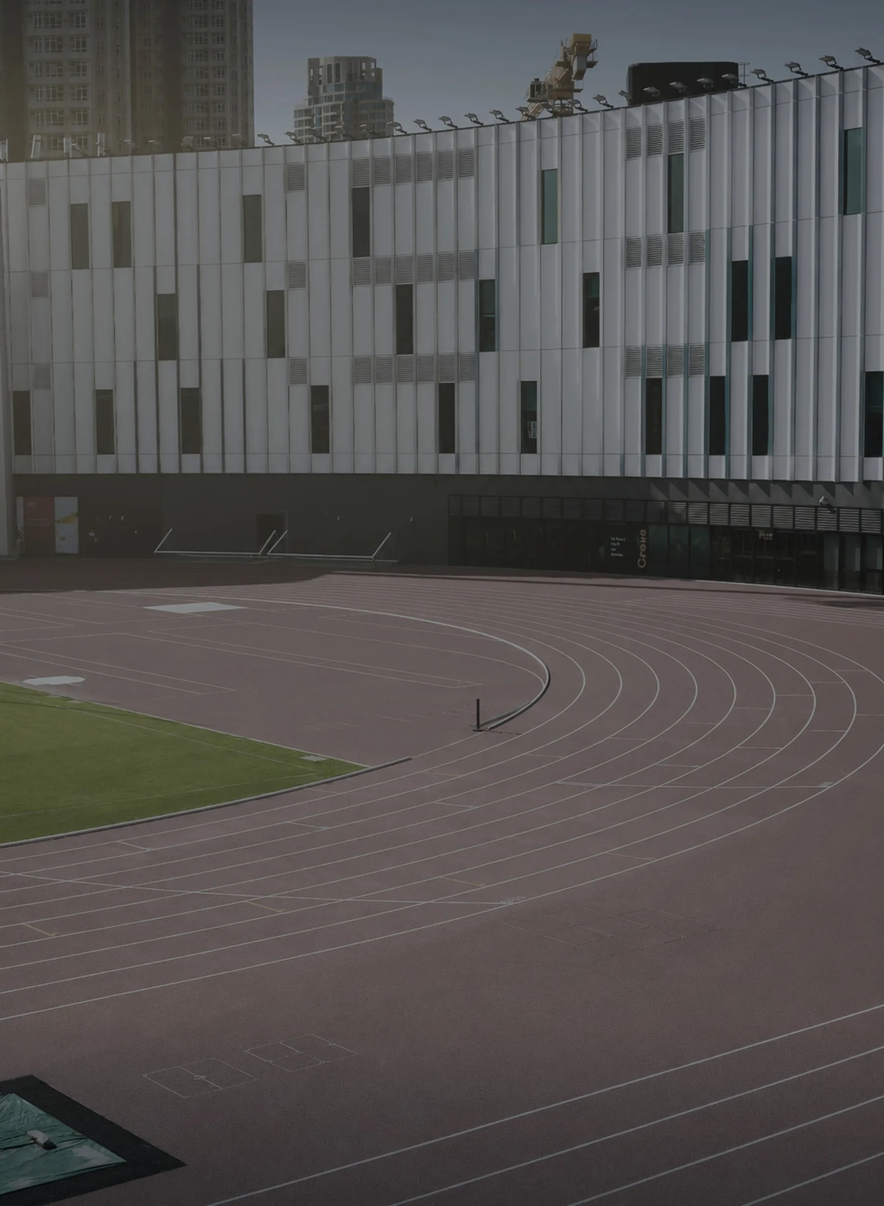 An empty athletic stadium and track at dawn